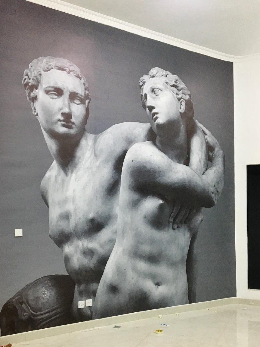 Large-format classical statue mural printed and installed across an interior wall